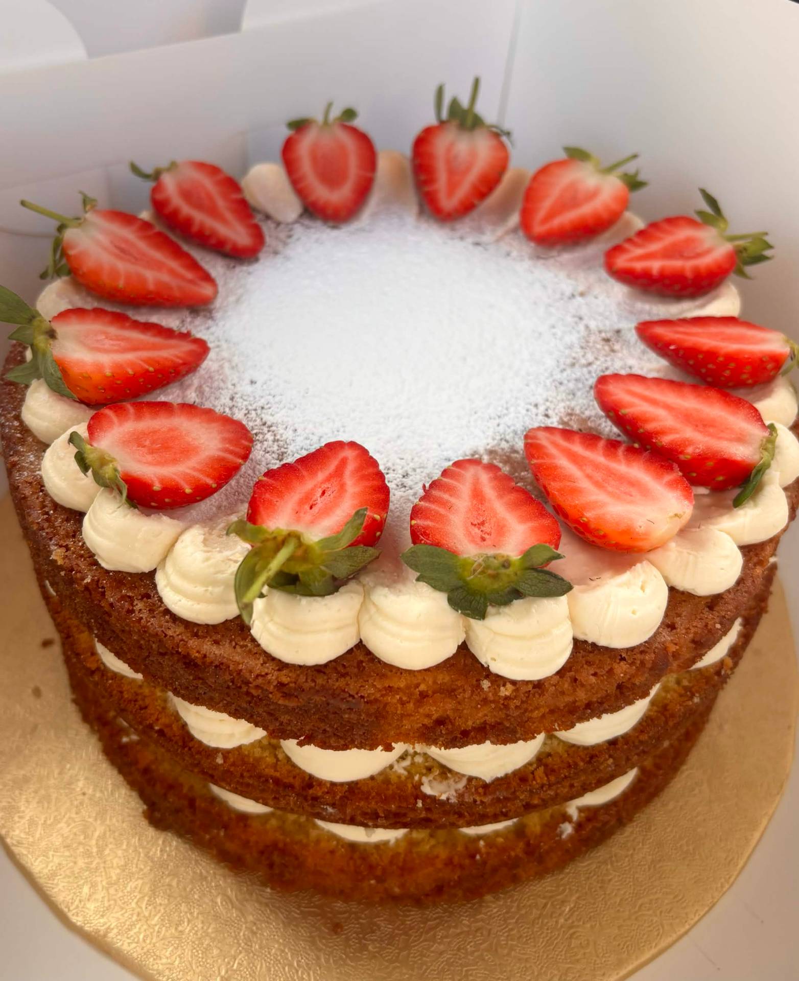 Layered vanilla sponge with cream and fresh strawberries