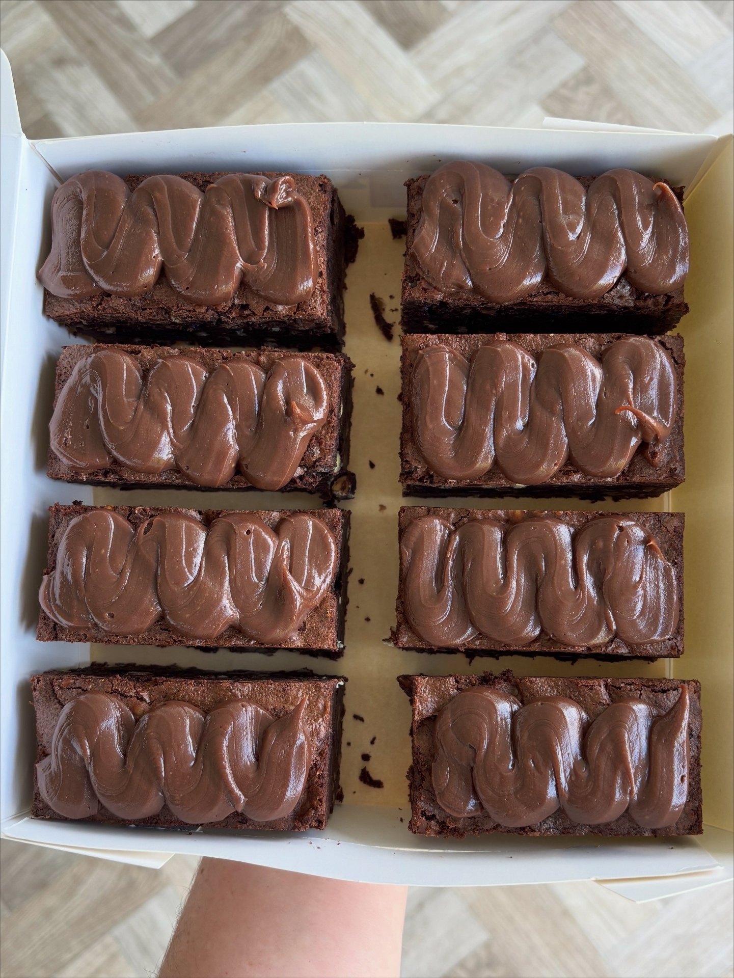 Box of eight chocolate brownies piped with swirls of chocolate hazelnut spread